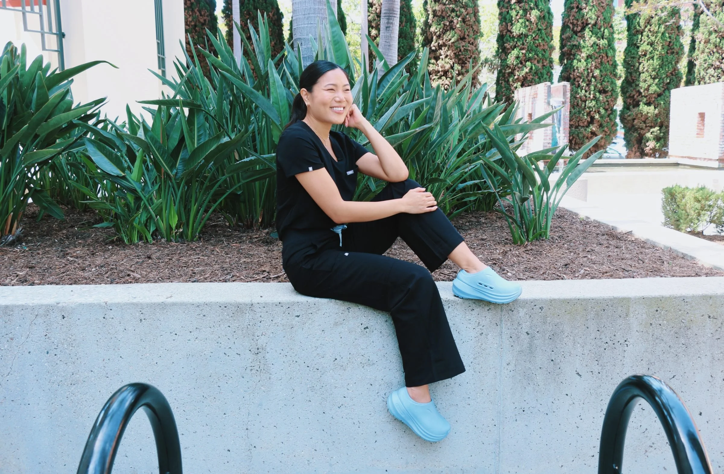 Small business owner smiling outdoors in a Los Angeles plaza, photographed by Rogue Dynamics