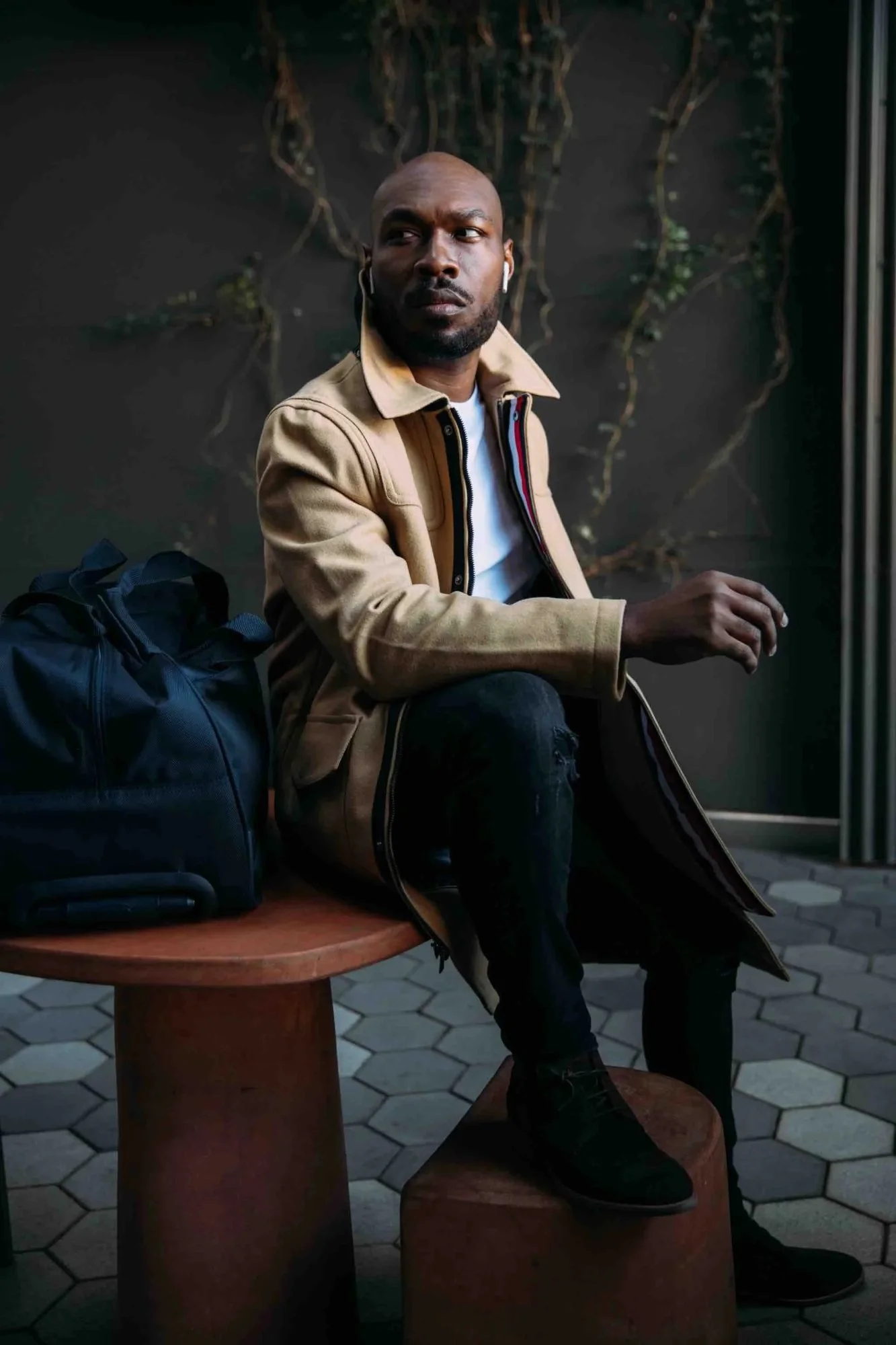 CJ Johnson in a camel overcoat, brand partnership editorial