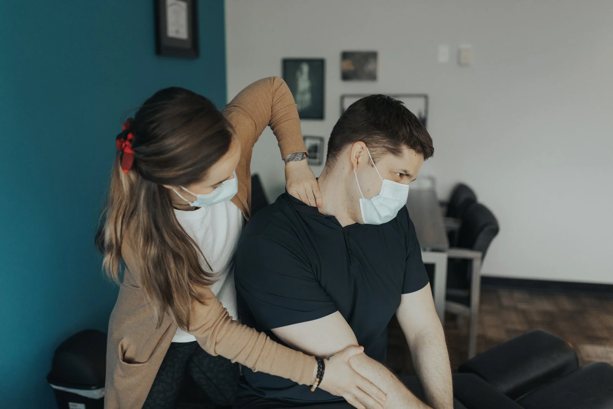Chiropractor treating a patient&rsquo;s shoulder and neck