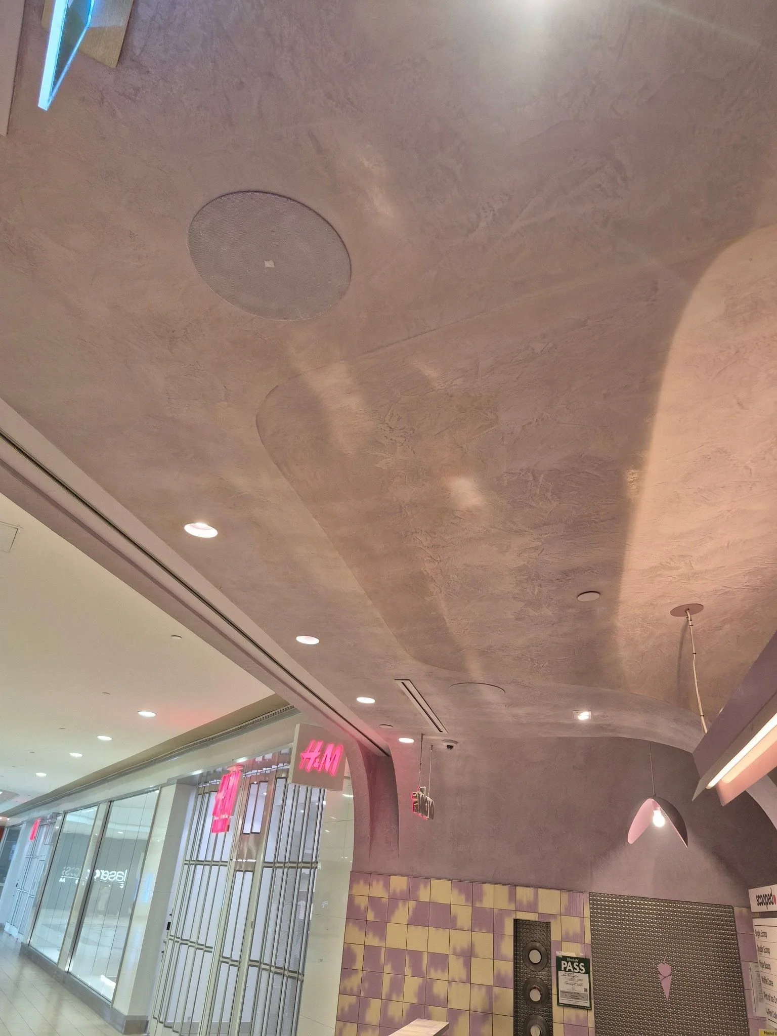 Textured plaster ceiling and curved archway inside the Scooped by Demetres ice cream shop.