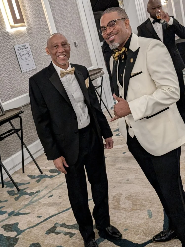 Brothers in black tie and a white dinner jacket at a past Holiday Scholarship Ball