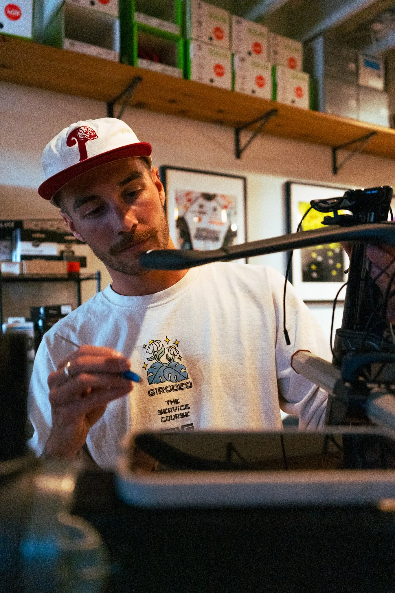A mechanic carefully adjusting a bike at Peak State Fit