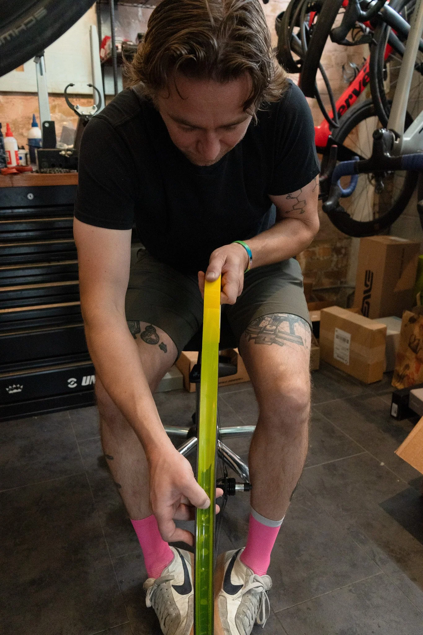 A Peak State Fit specialist taking a precise bike-fit measurement