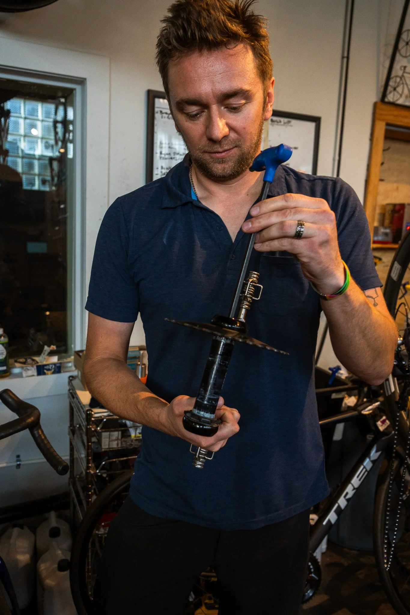 Chris Yeager working on a bicycle fork at Peak State Fit