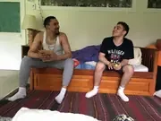 Two participants talking on a couch beside a sunny window.