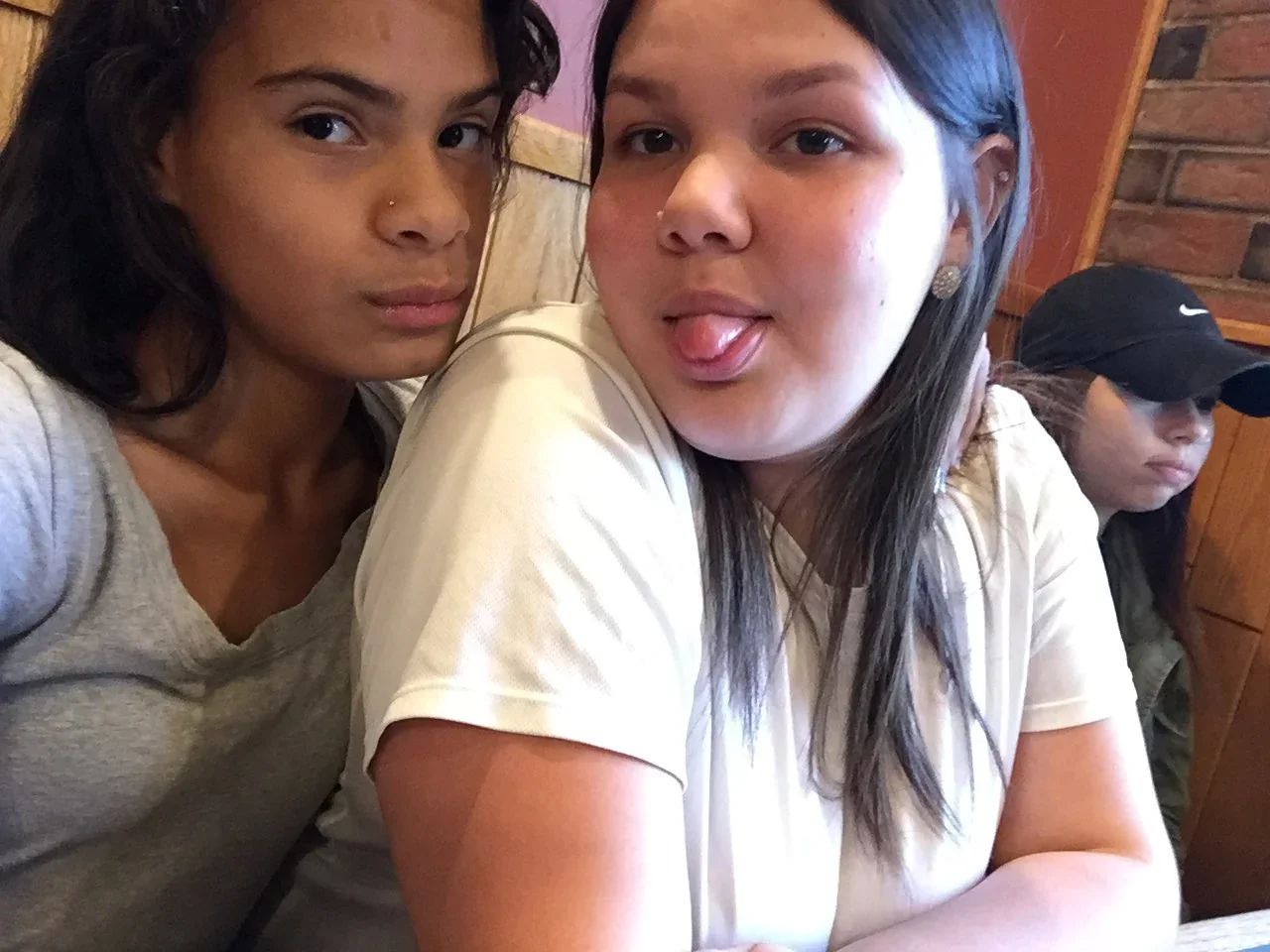 Two participants posing together at an indoor gathering.