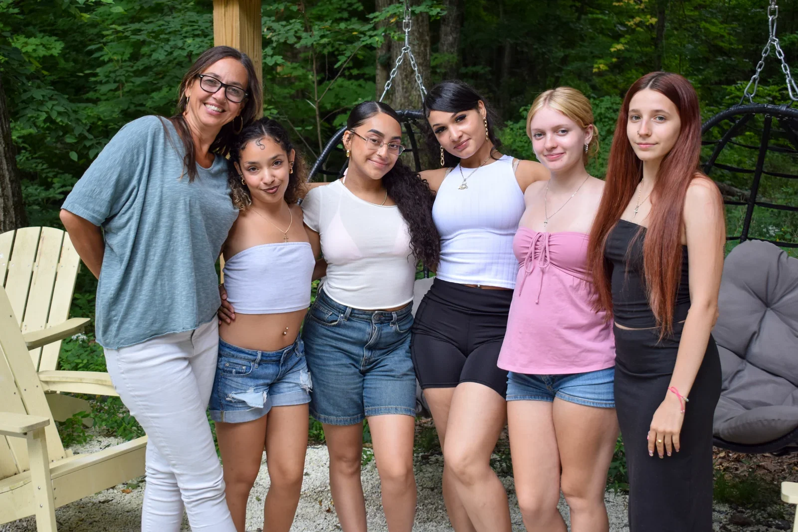 Participants standing together beside a deck in the woods.