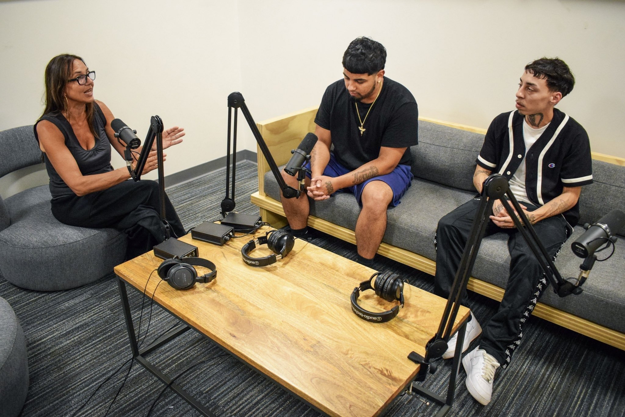 A podcast conversation being recorded in the studio.
