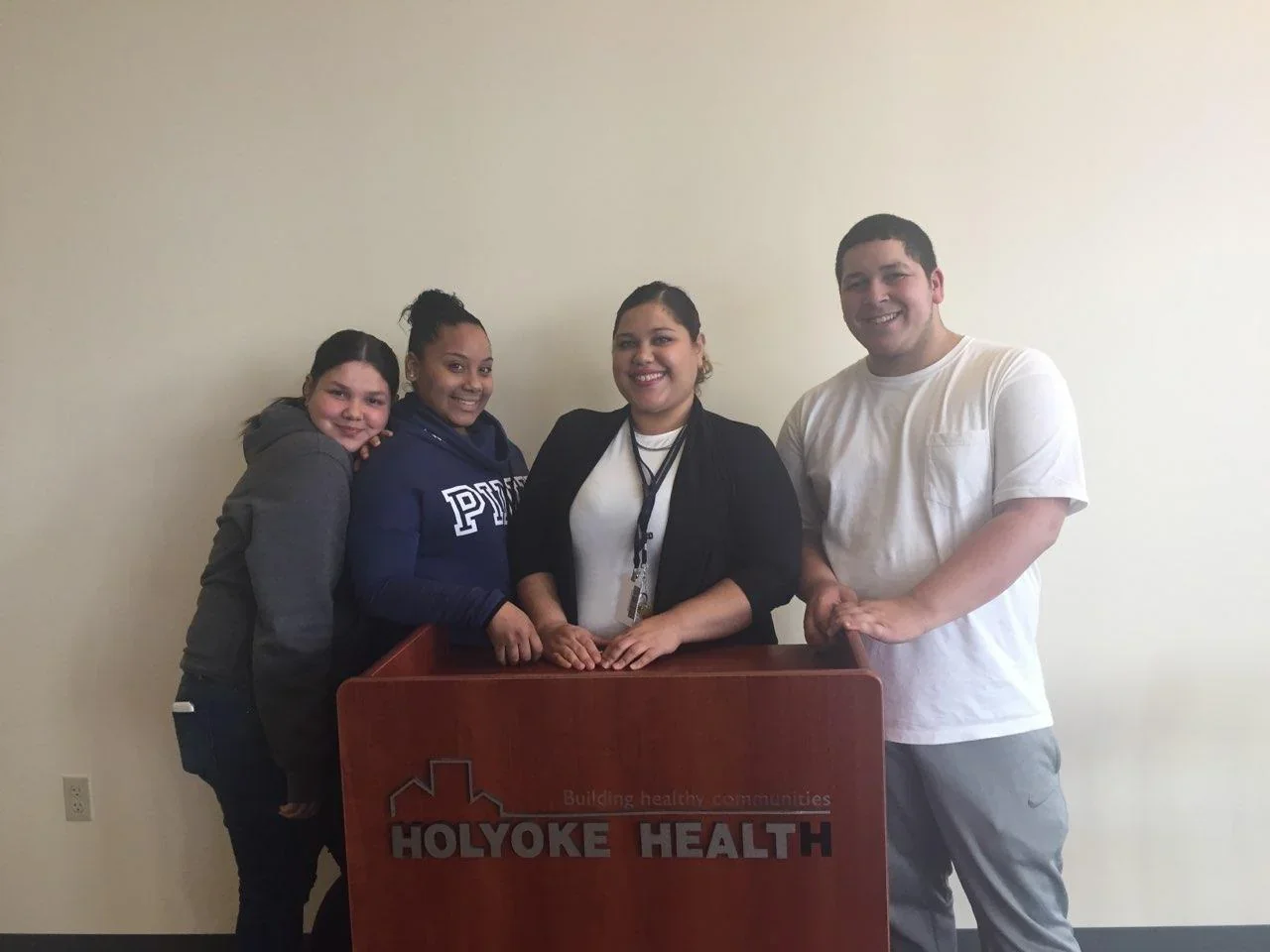 Four participants standing together behind a Holyoke Health lectern.