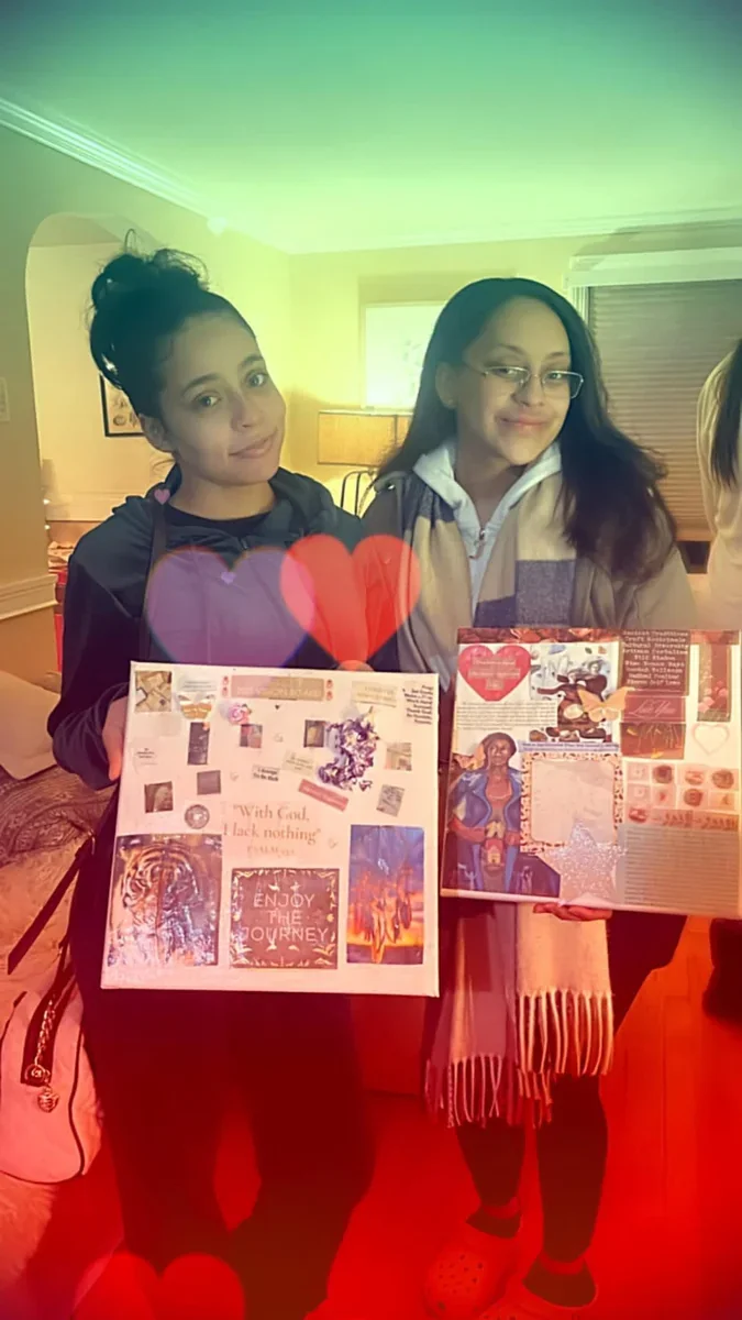 Two participants displaying their collage artwork.