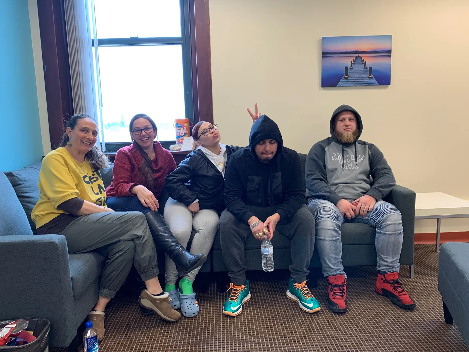 Five participants seated together on a couch.