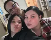 Three people posing for a close-up group selfie.