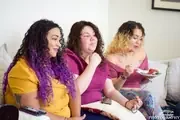 Three participants sharing a conversation on a couch.