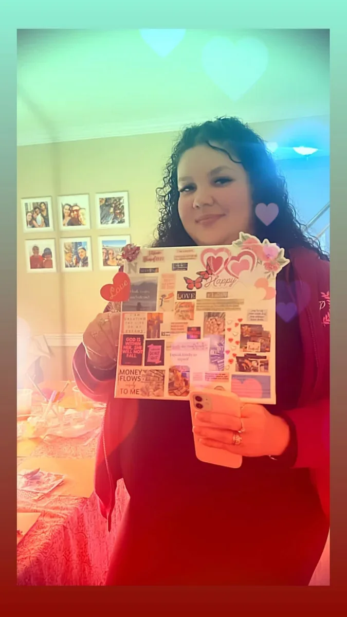 A participant holding up a colorful collage.