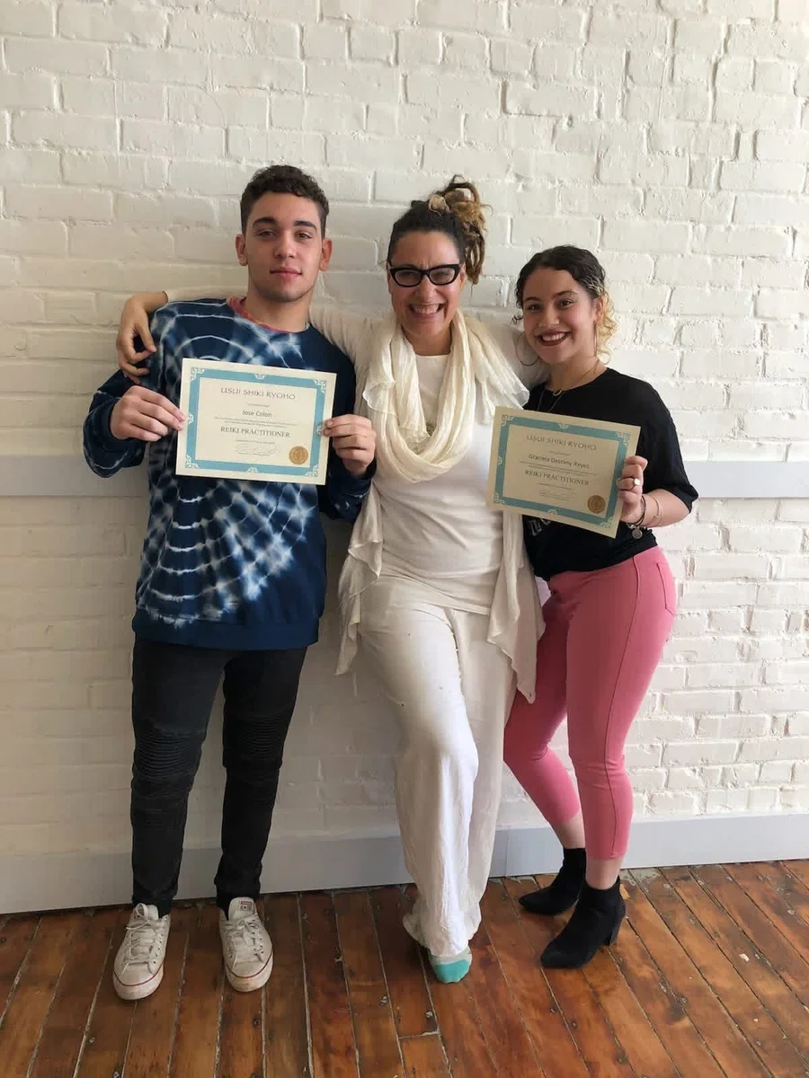Three people celebrating with certificates.