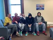 Five participants seated together on a couch.