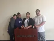 Four participants standing together behind a Holyoke Health lectern.