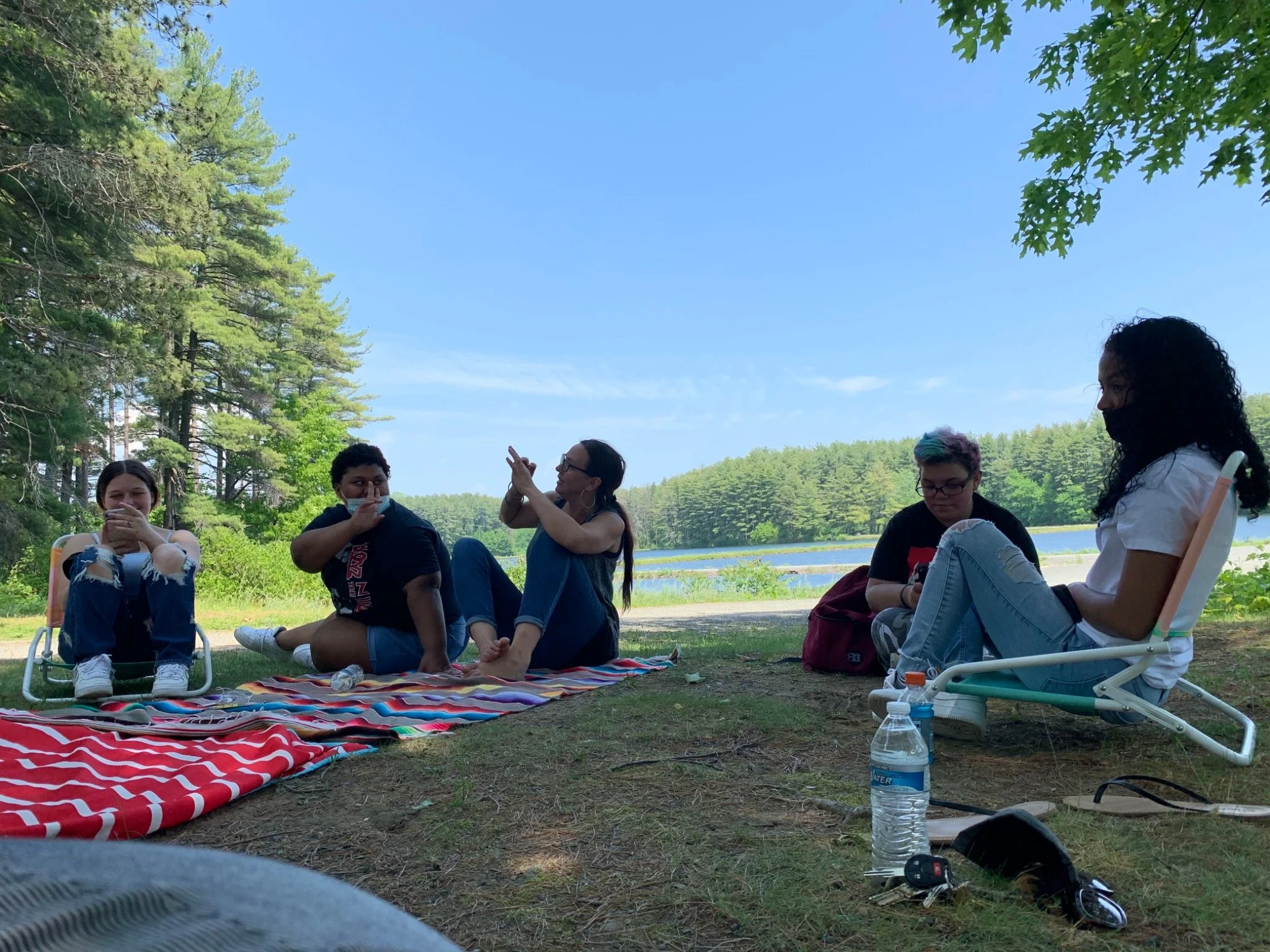Youth Leadership Squad participants gathered outdoors by the reservoir.