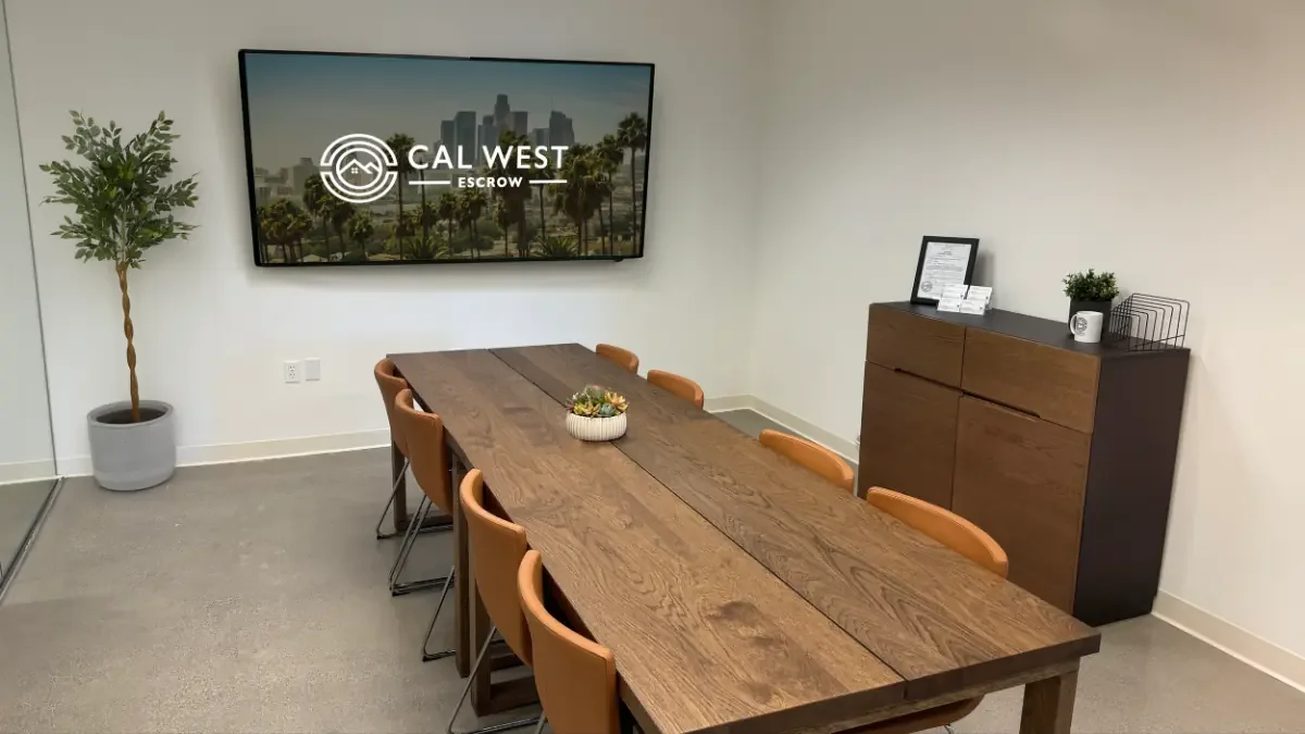 Cal West Escrow’s conference room in Downtown Los Angeles, with the Cal West logo on the wall screen
