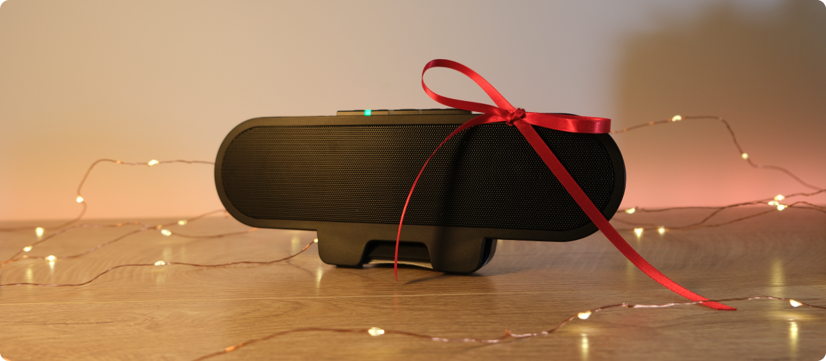 Desk setup with a Cyber Acoustics speaker bar mounted on a monitor