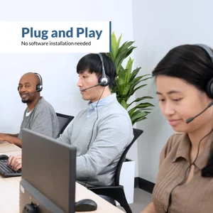 Three office workers wearing AC-204 wired PC headsets at desktop computers — plug and play 3.5mm headset works instantly with Windows PCs, no software or drivers needed for Zoom, Teams, or voice calls