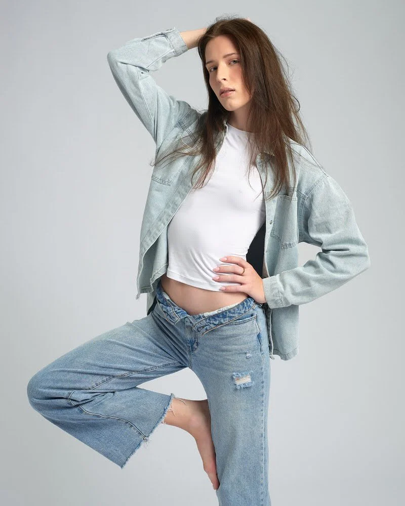 Full-length image of a model in a denim jacket and jeans