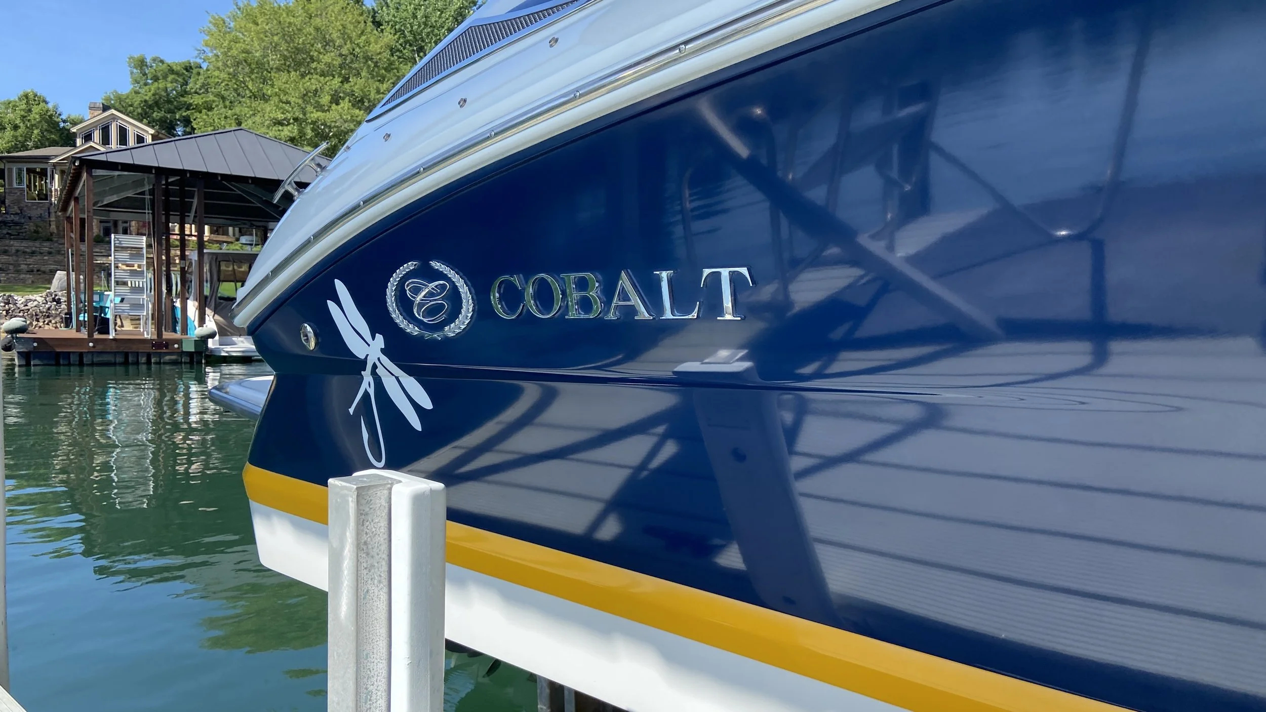 Close-up of restored gelcoat on Cobalt boat at dock — deep shine, sharp decals, flawless finish