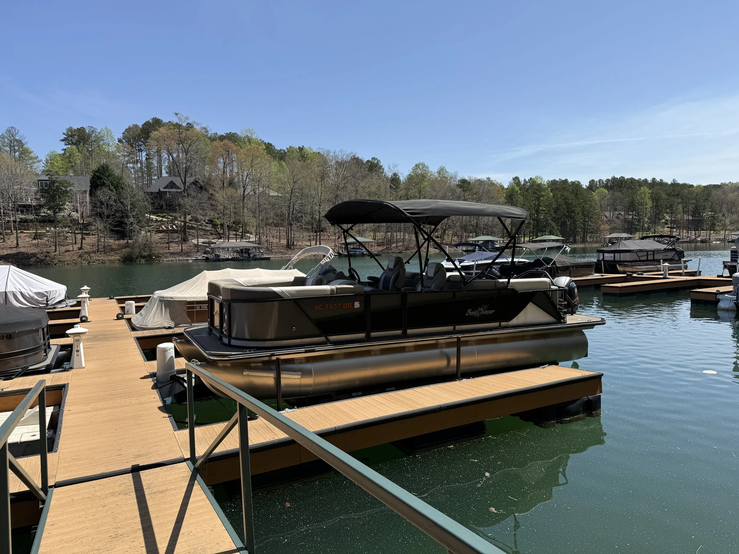 Premium detailed boat exterior on Lake Keowee — deep gloss, clean waterline, oxidation removed