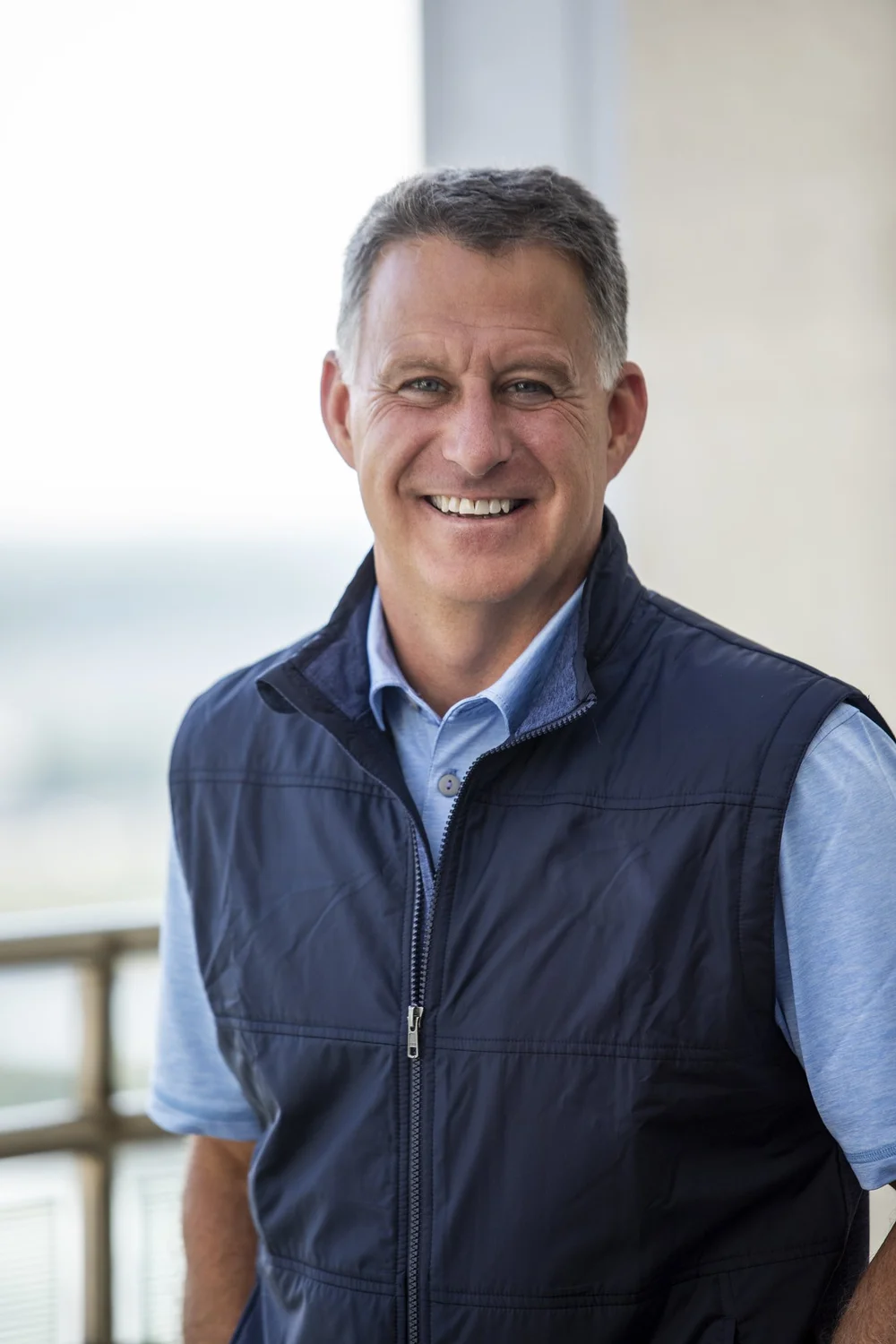 Professional corporate headshot — businessman in suit with clean background