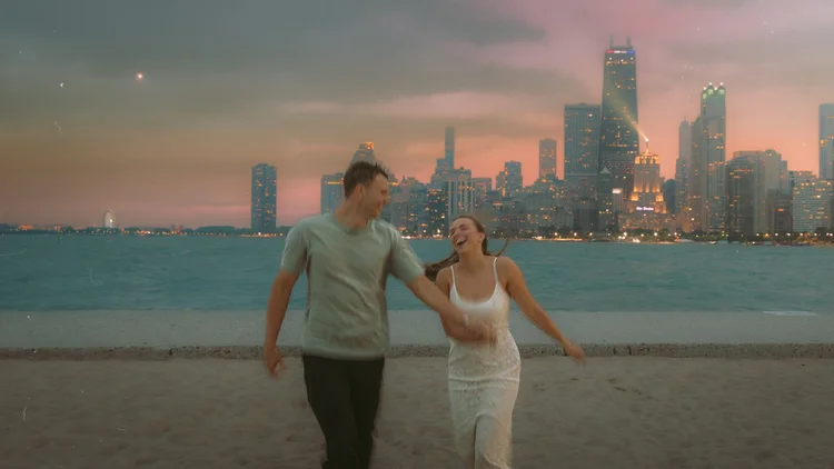 A couple running along North Avenue Beach in motion blur under a pink storm sky with the Chicago skyline behind them, a proposal portrait by Jeremy Glickstein