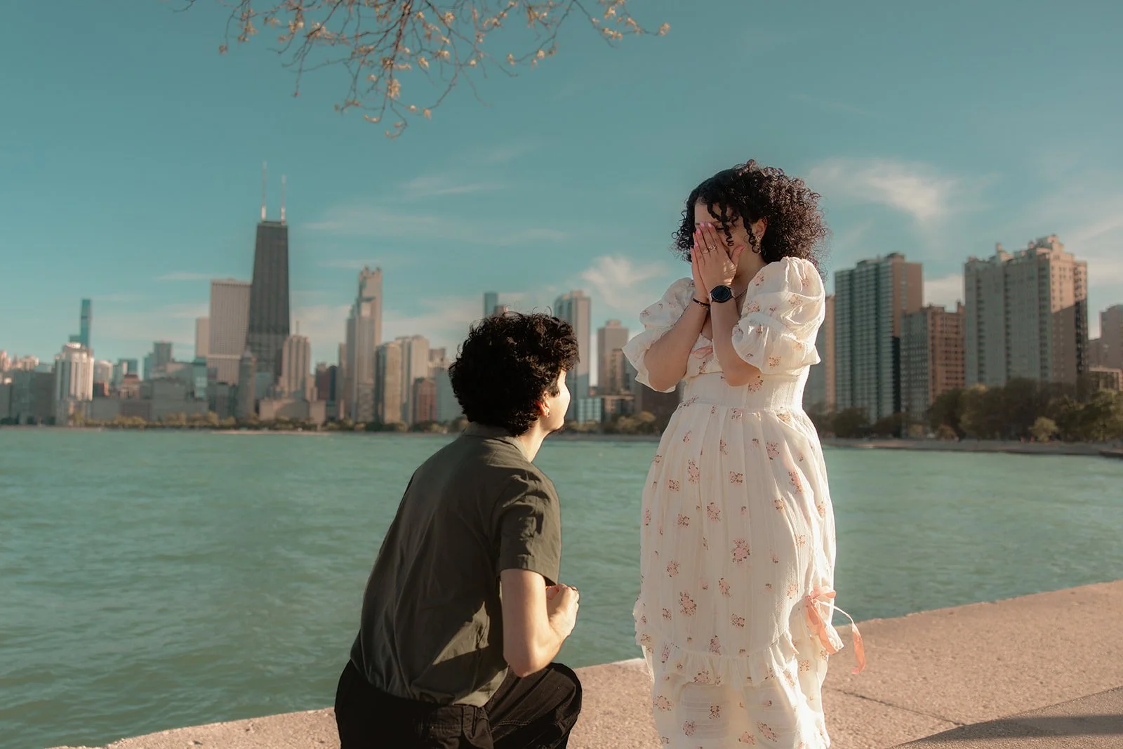 Ally's reaction to the proposal, hands to her face, overcome with emotion at North Avenue Beach