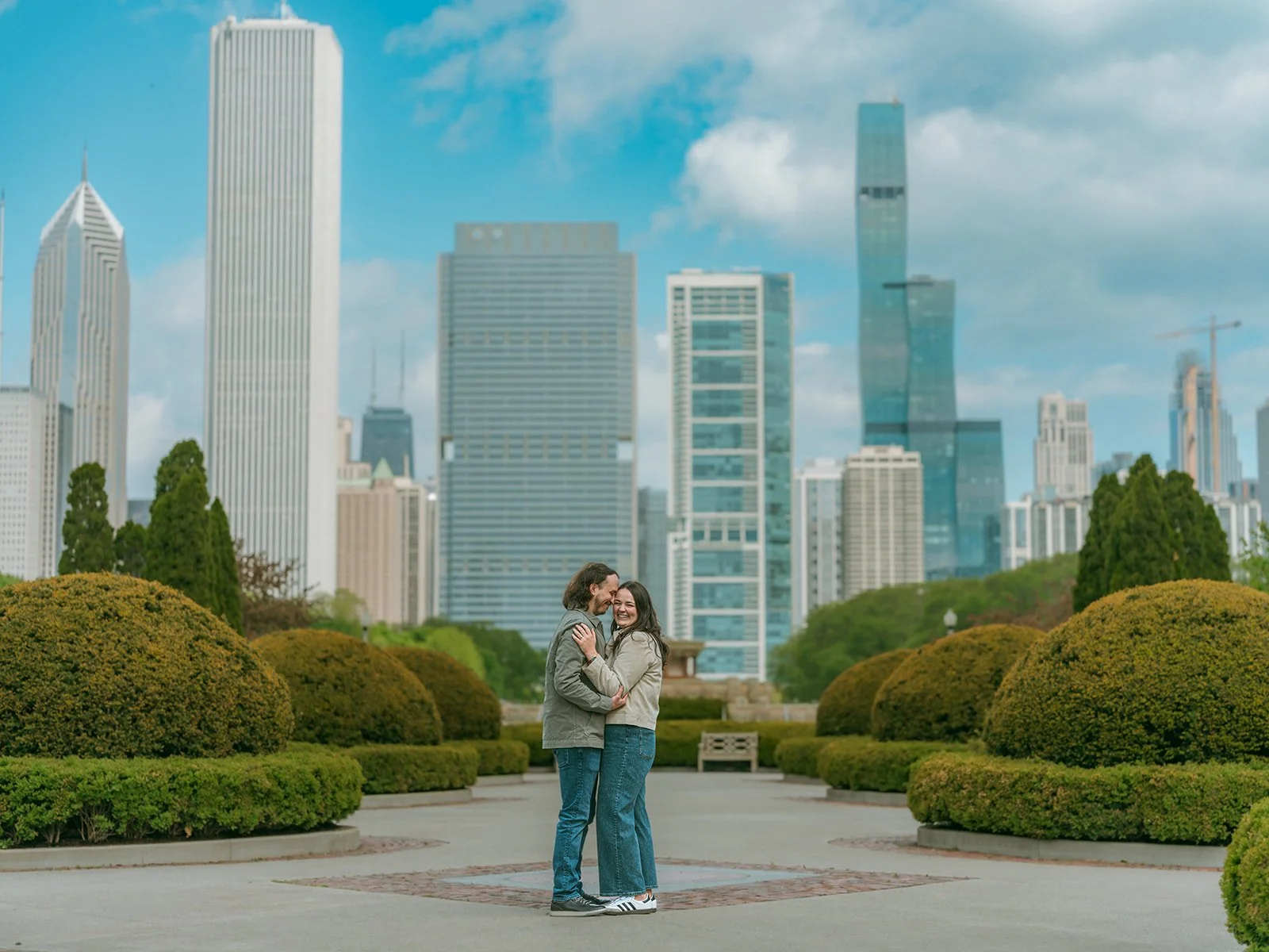 Surprise proposal at Buckingham Fountain in downtown Chicago, photographed by Jeremy Glickstein Photography for an out-of-state couple