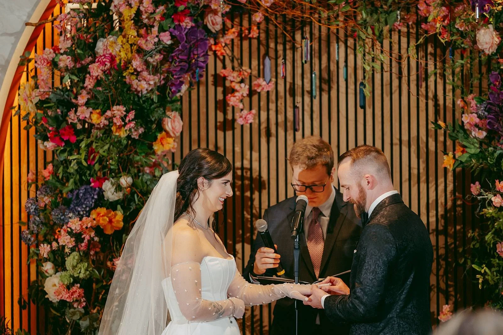 Exchanging rings during candlelit ceremony