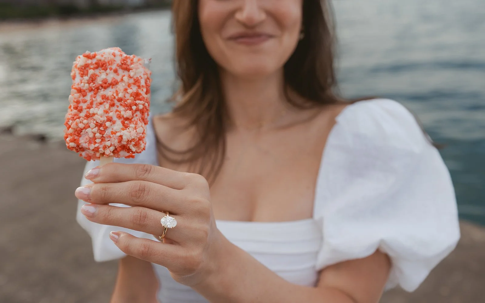 Proposal setup with white roses and champagne on the beach
