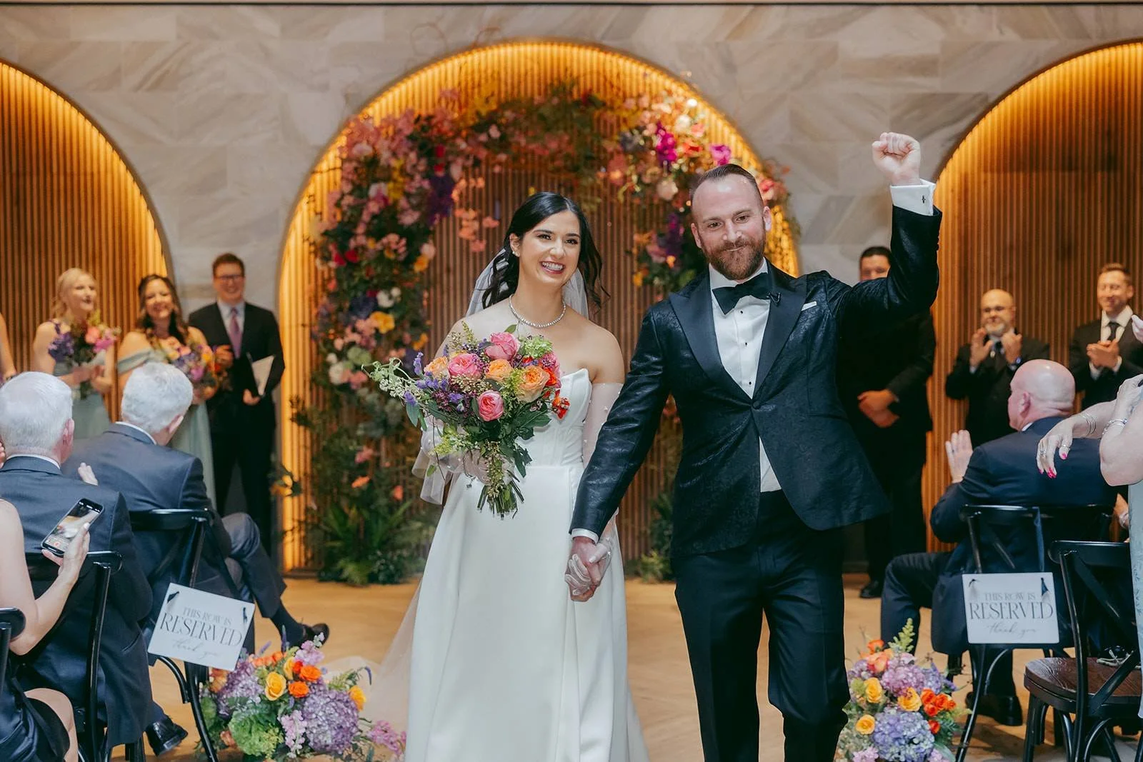 Just married recessional under floral arch