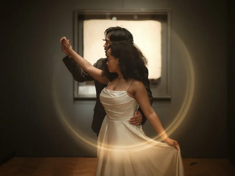A couple dancing inside a warm circular trail of light at the Art Institute of Chicago, a fine art proposal portrait by Jeremy Glickstein