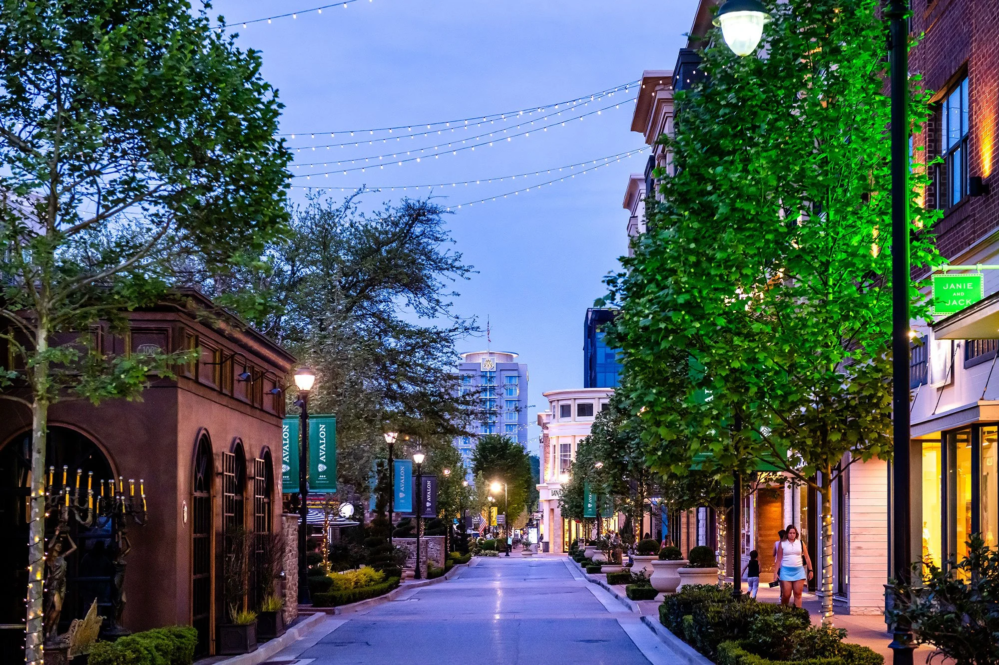Avalon district at dusk, Alpharetta GA — string lights and tree-lined walkway