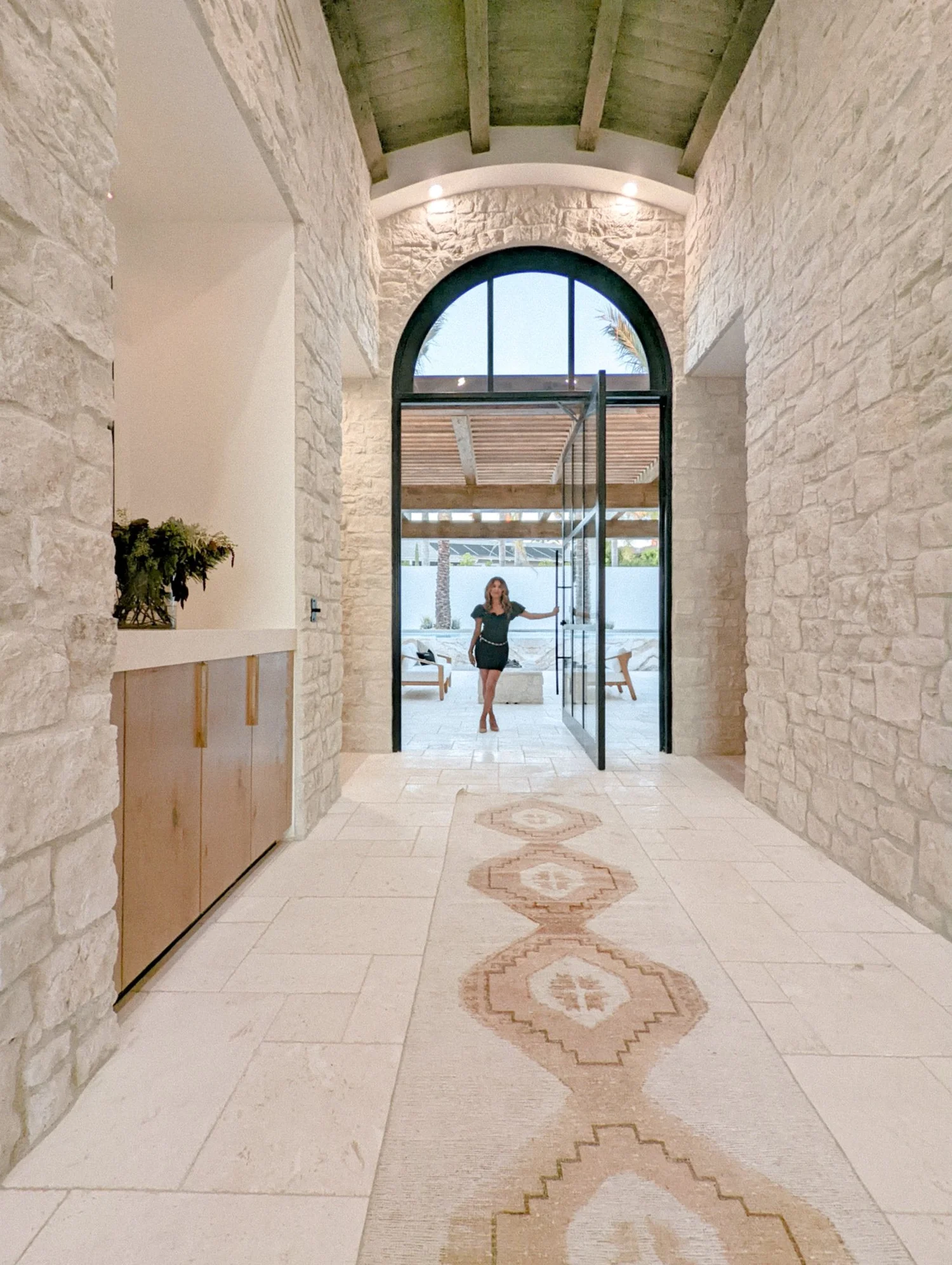 Shirley Slee in an airy entryway with an arched doorway