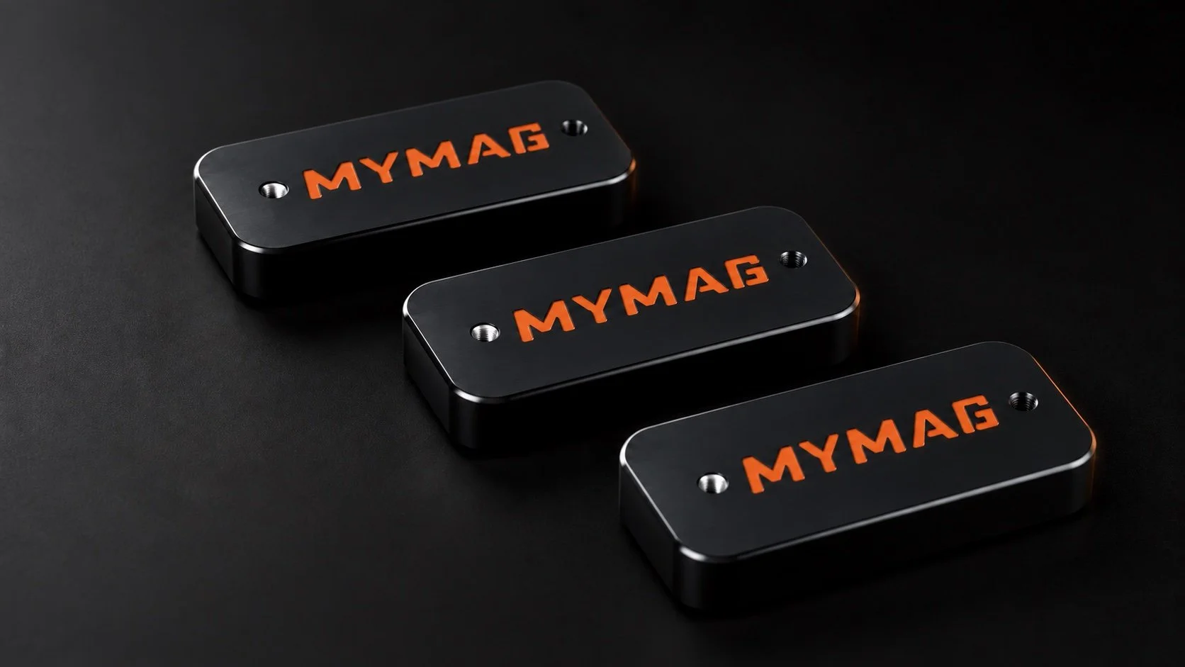 Black MYMAG machined magazine bases with orange MYMAG logos