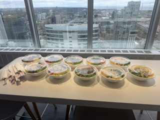 Ten Pokerrito bowls lined up on an office table for a downtown Toronto team
