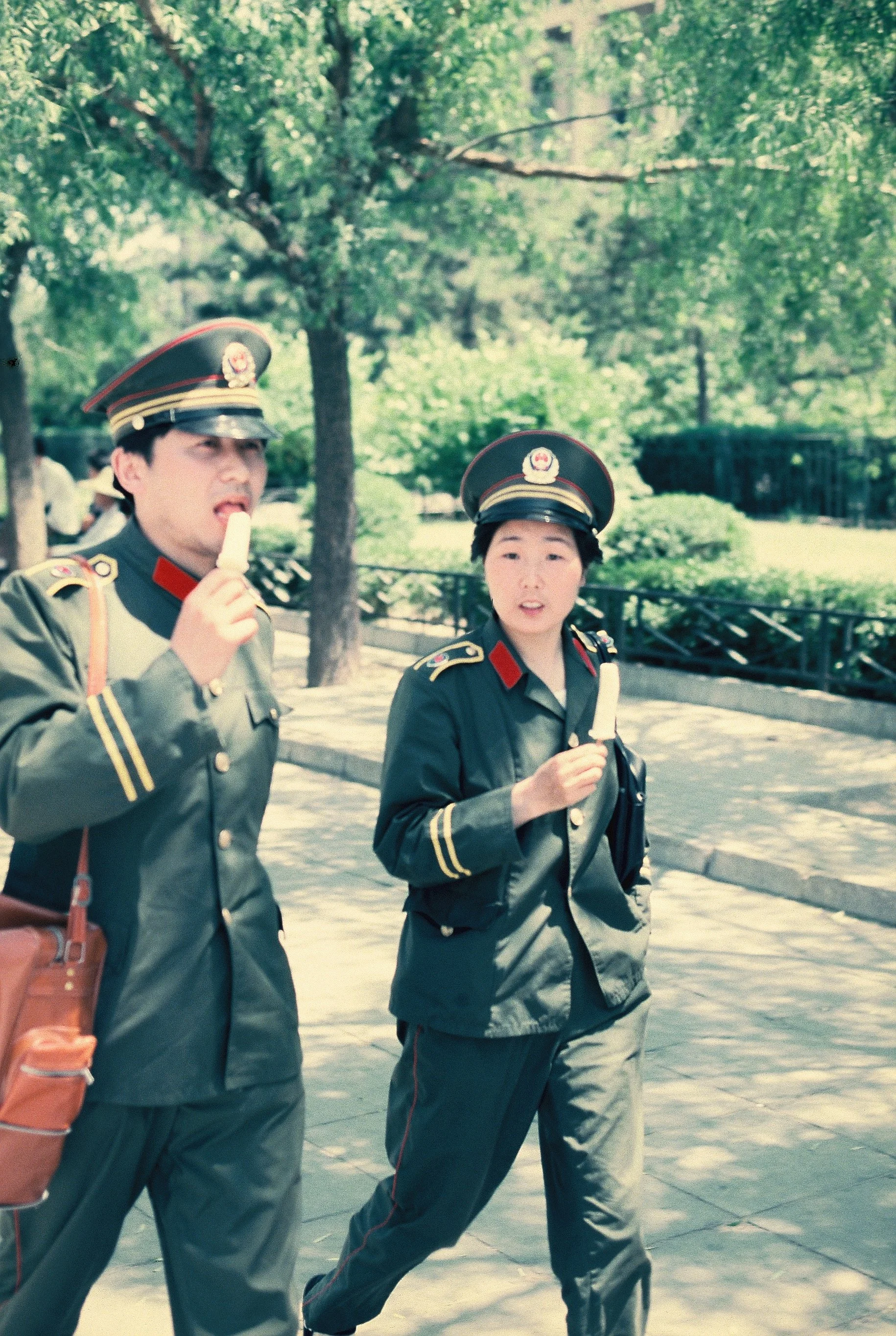 Police man and woman with popsicles, Beijing