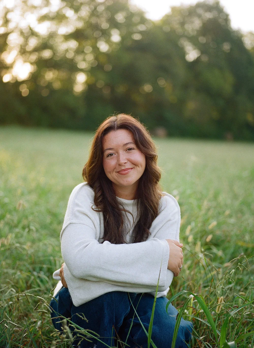 katie smiling in a meadow