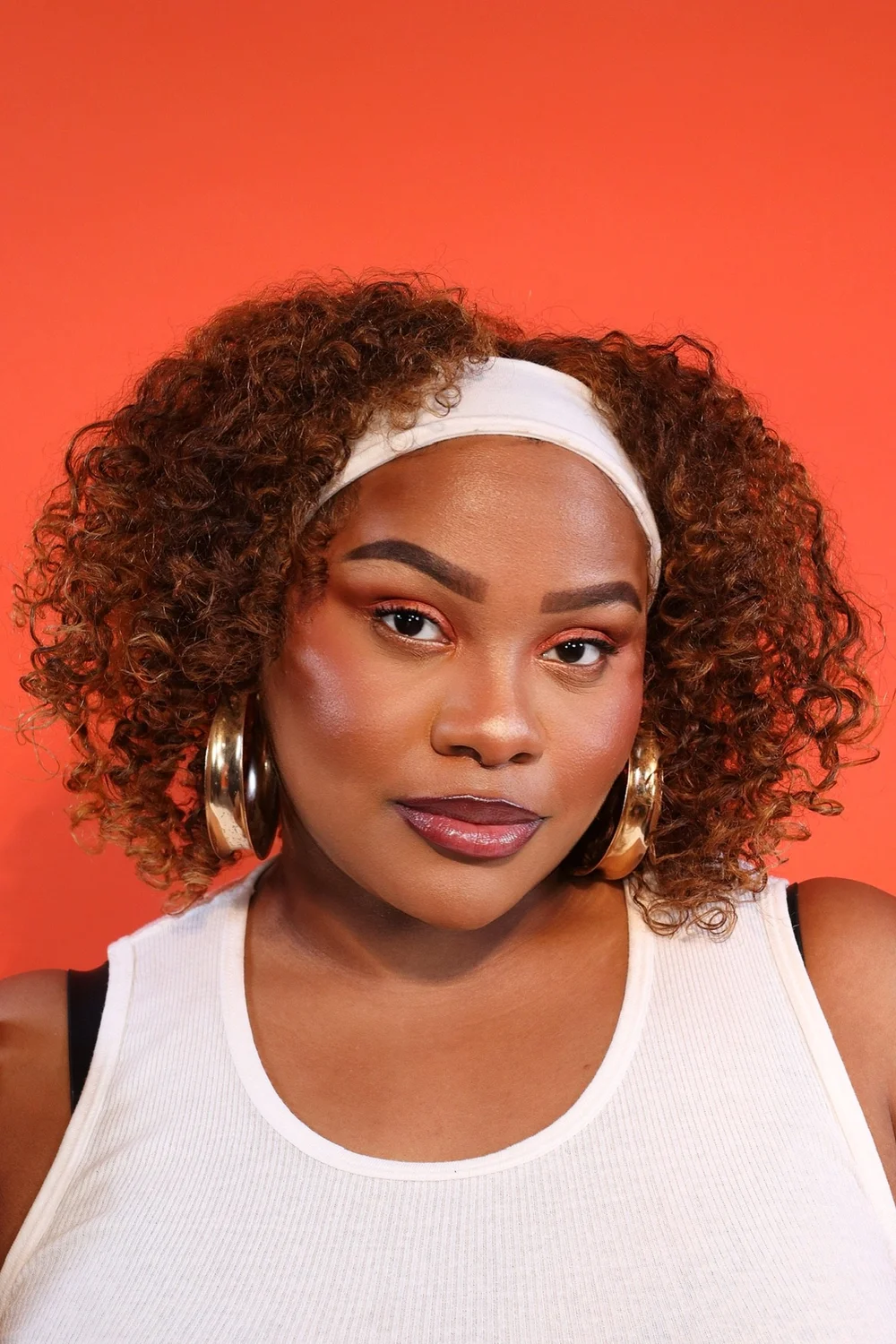 Beauty portrait against a vivid orange background