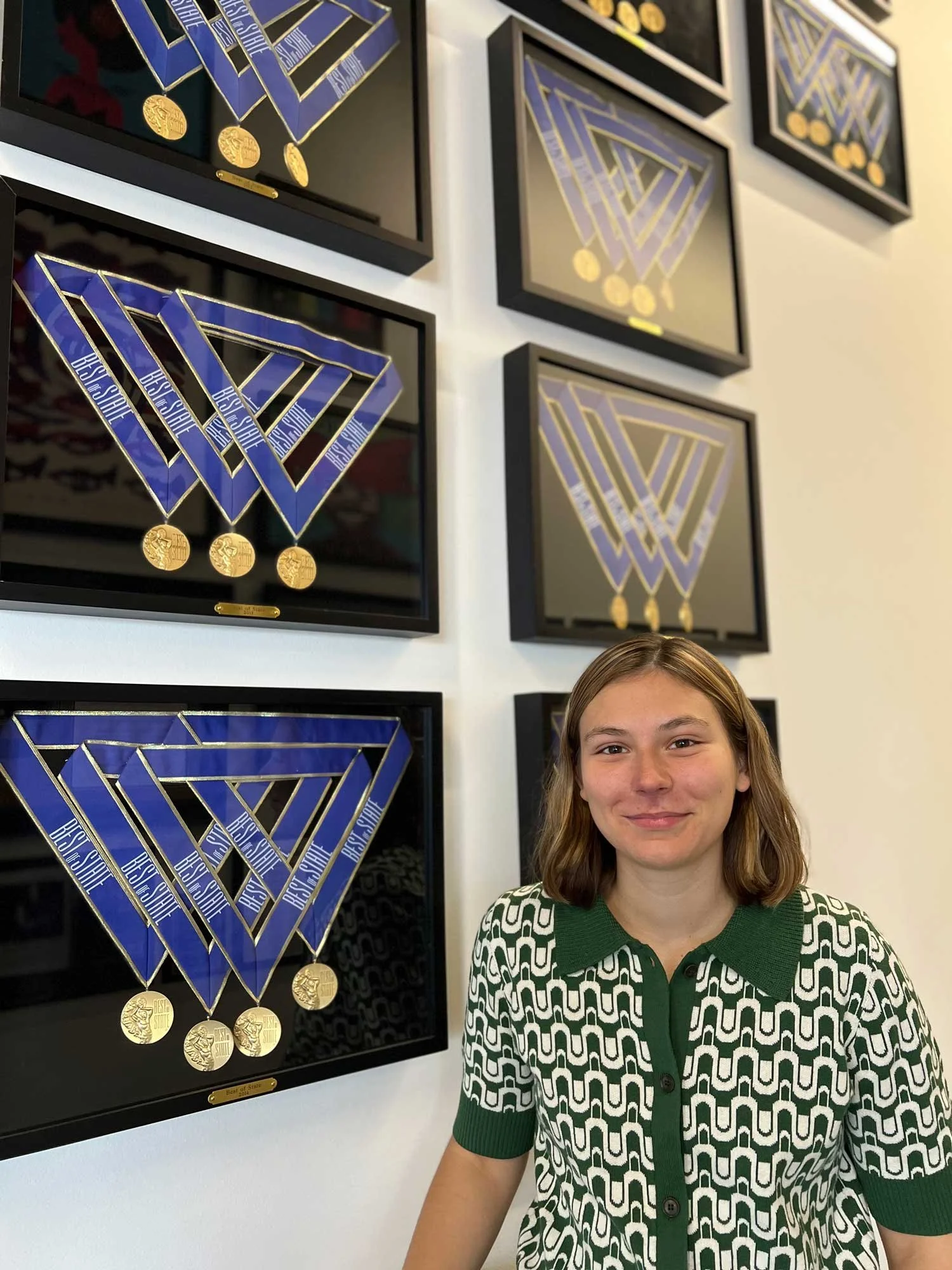 Sofia Detjen with framed music award certificates
