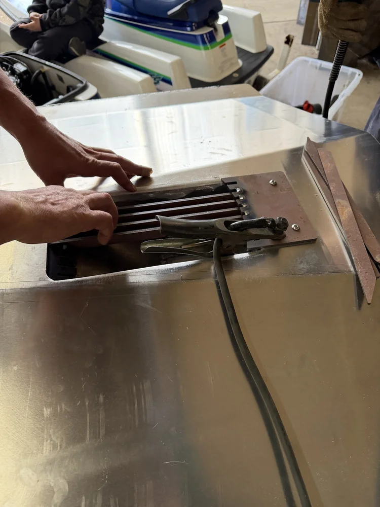 Intake grate bars being positioned in the hull opening