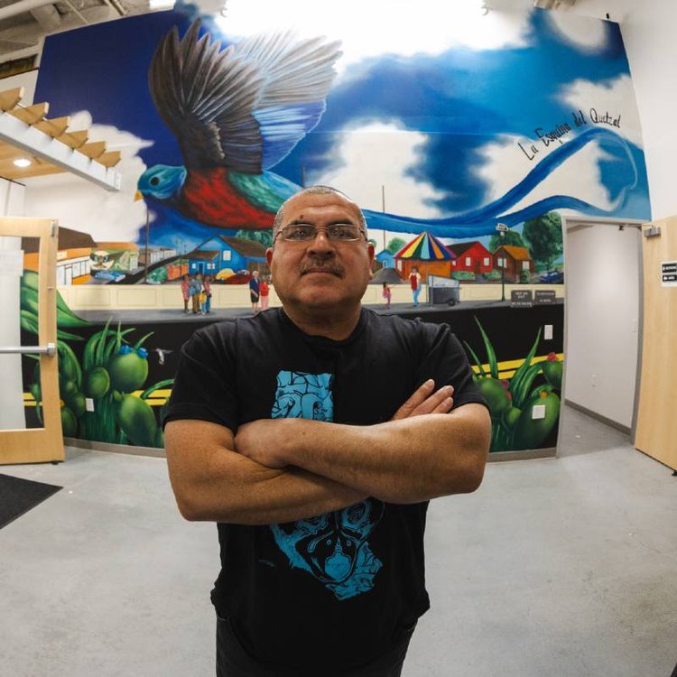 Artist Tomas "Wisper" Talamantes stands proudly in front of his new mural "Freedom," located in East San Jose.