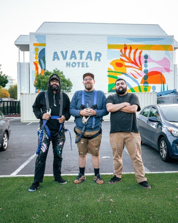 From L to R: Jorge "J Duh" Camacho, Ben Henderson, and Andrew Sumner in front of their Avatar Hotel mural.