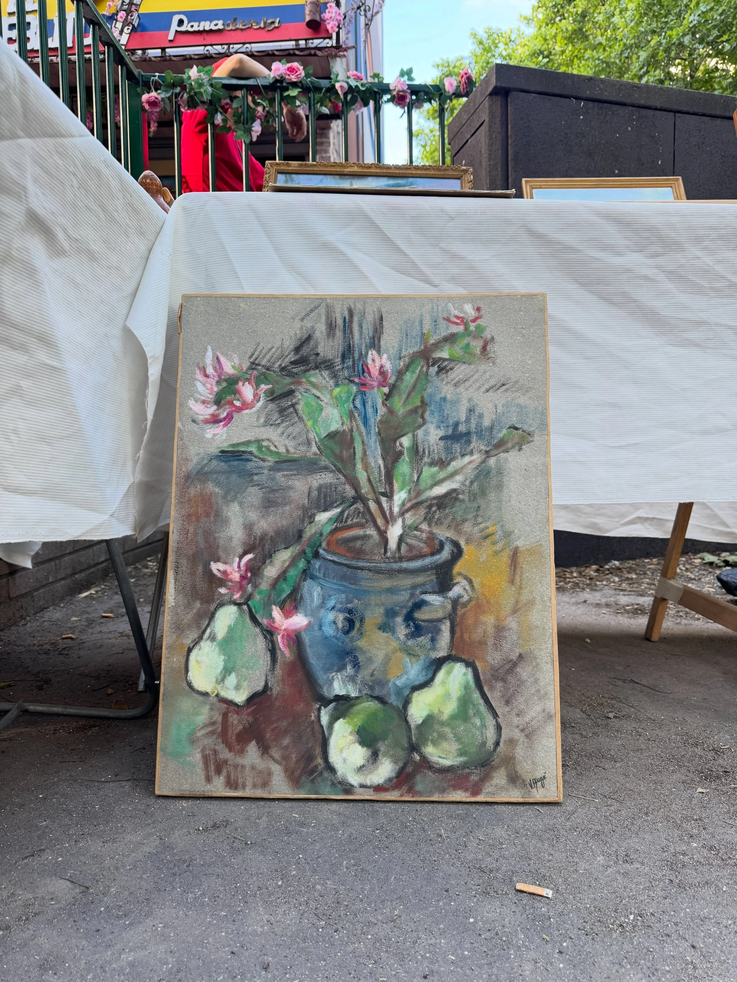 Framed floral still-life painting at a Paris flea market.