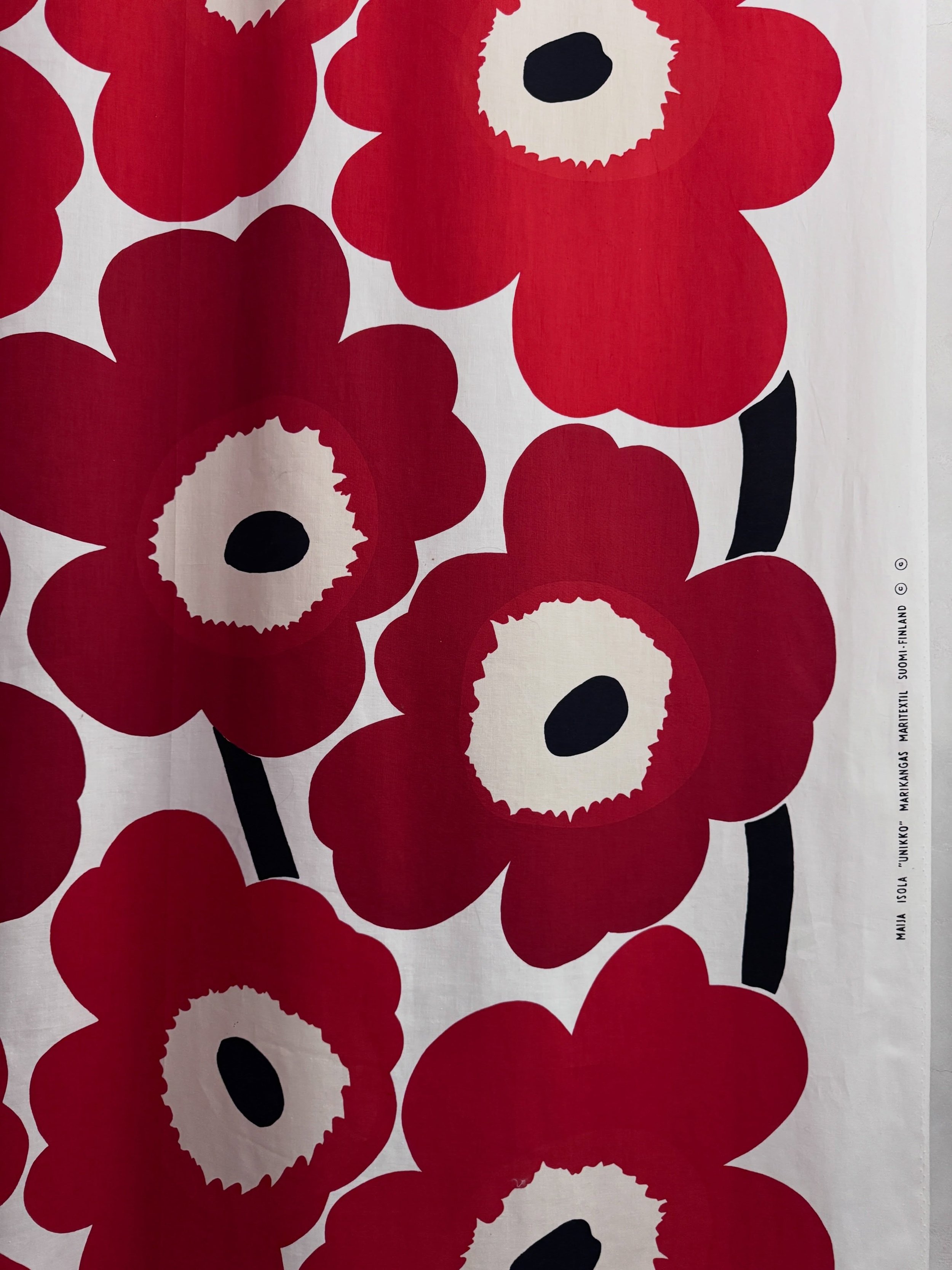 Red, white, and black floral textile displayed at Designmuseum Danmark.