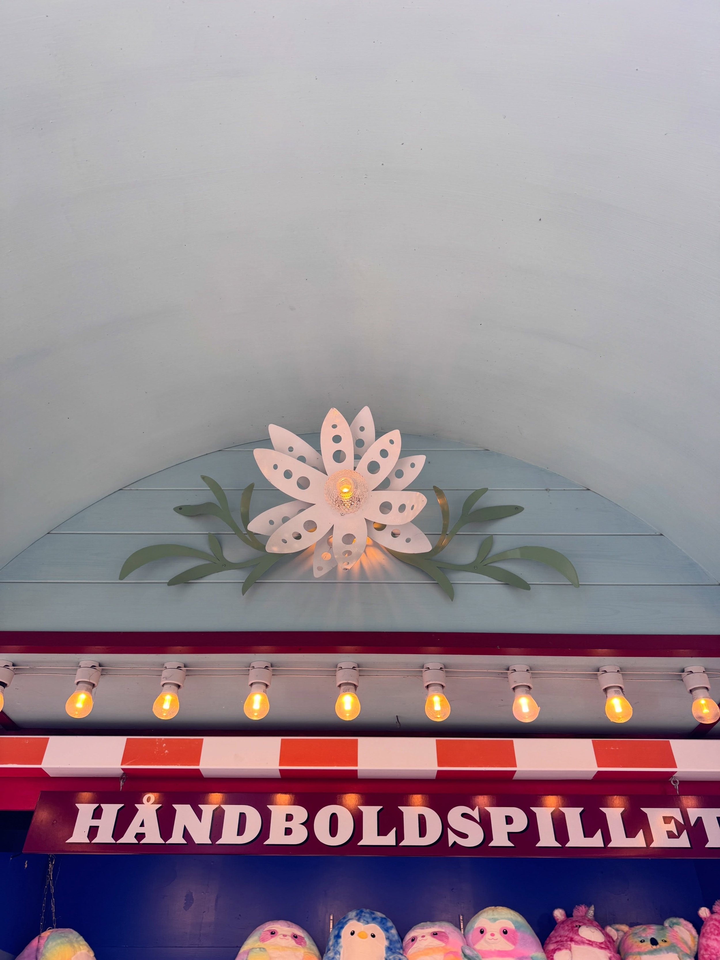 Painted floral crest and illuminated sign at Tivoli Gardens in Copenhagen.